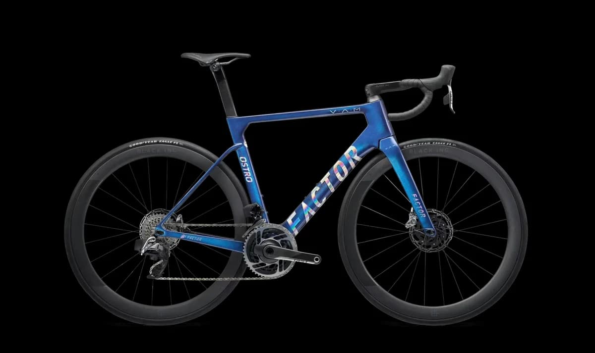 A blue Factor Ostro VAM road bike on a black background